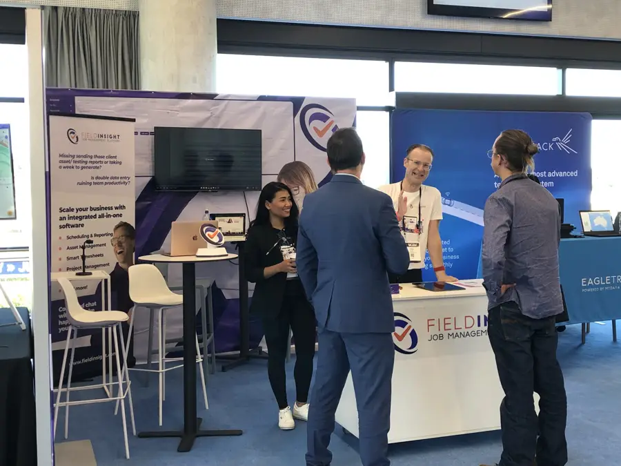 FieldInsight trade show booth with visitors
