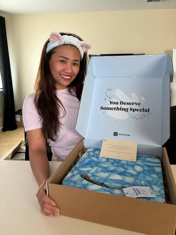 Joy opening a thank you gift box from Intercom
