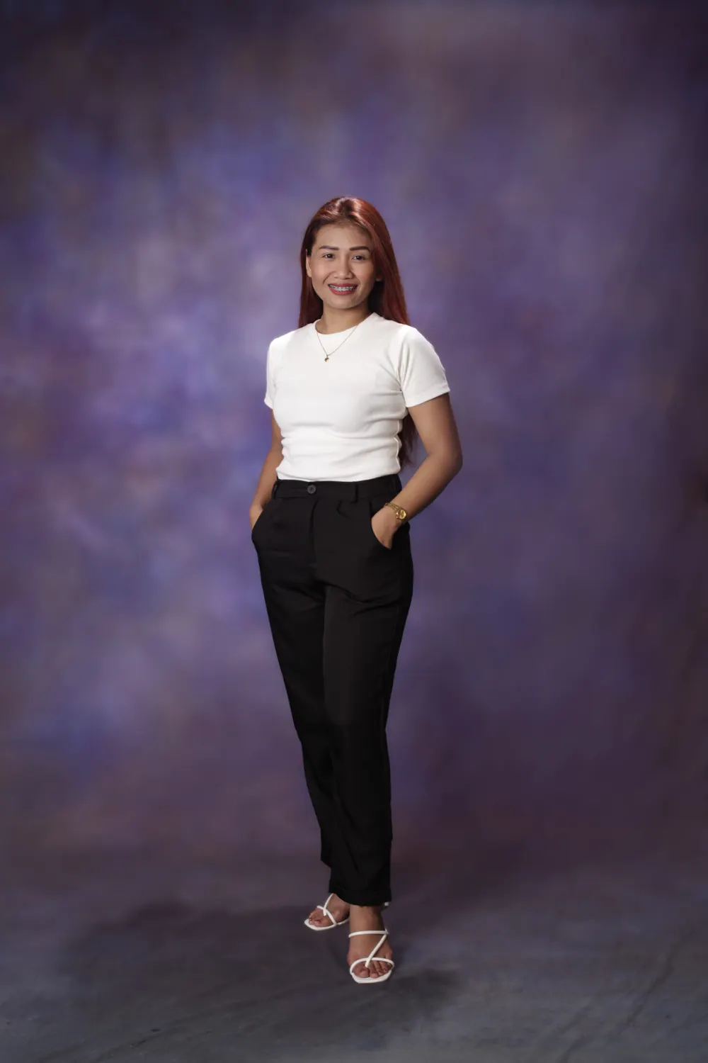 Joy Gallagher, full length, in front of a purple studio backdrop